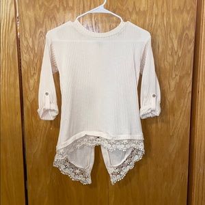 cream colored blouse with lace detail & open back